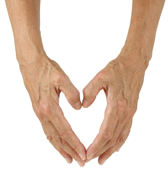 das Zeichen der Liebe - weibliche Hände, die vor weißem Hintergrund eine Herzform formen - Foto, Bild