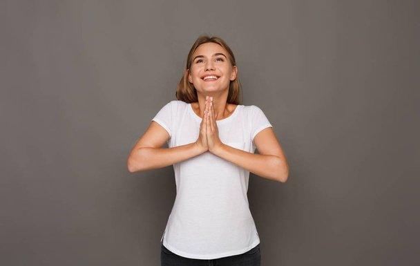 Happy woman with praying hands portrait - Photo, Image