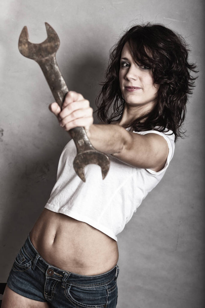 Sexy girl holding wrench spanner tool - Fotoğraf, Görsel