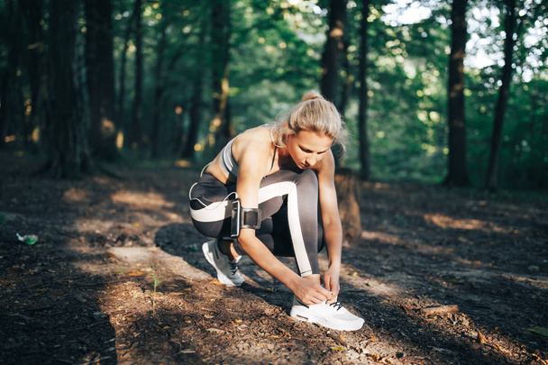 Sports woman runner tying shoelace - Photo, Image