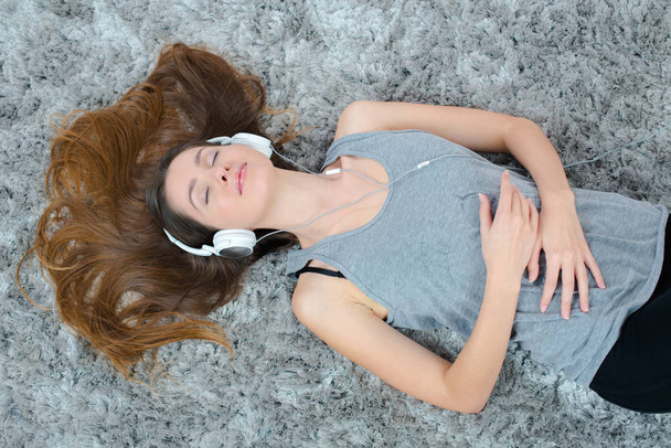 young beautiful woman headphones listening music on the floor - Foto, imagen