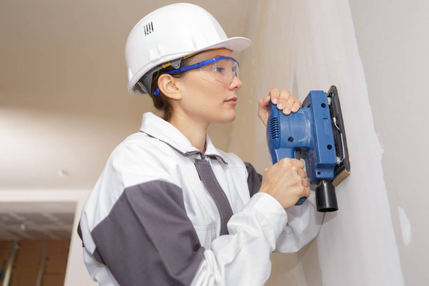 woman plasterer polishing the wall - Photo, Image