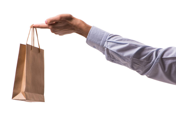 Hand holding shopping bags with christmas shopping on white back - Photo, Image