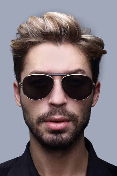 Close-up portrait of handsome stylish man in sunglasses. - Fotó, kép