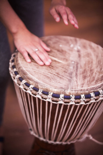 Close up shot of a bongo drum and a hand. - Photo, Image