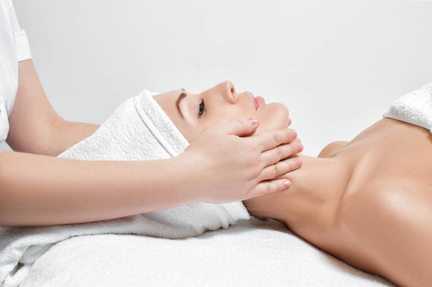 woman receiving facial massage at spa salon - Fotoğraf, Görsel