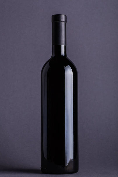 Red wine bottle on grey - Photo, Image