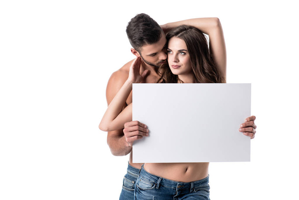  young sensual couple in jeans with blank board isolated on white - Photo, Image