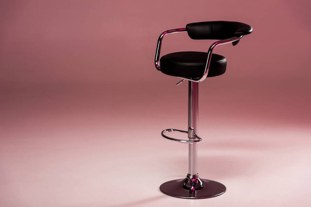 Metallic bar stool infront of pink background - Foto, imagen