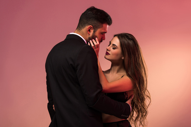 young handsome businessman hugging with pretty girl in lingerie - Photo, Image