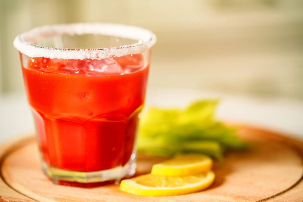 Bloody Mary alcoholic drink with lemon and celery - Photo, Image
