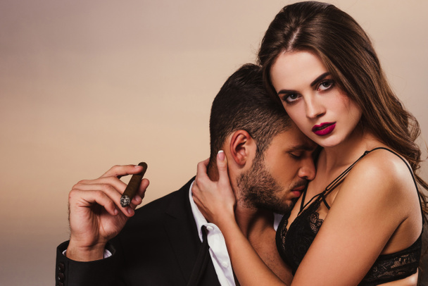 handsome businessman with cigar kissing beautiful girl in lingerie - Fotografie, Obrázek