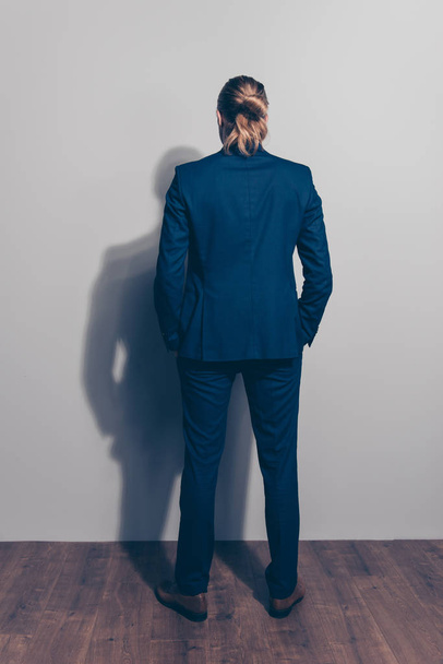 Full length back view of a man standing close to grey  wall, wea - Foto, imagen