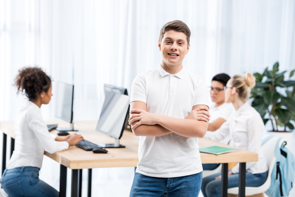 young happy caucasian student boy in classroom with friends - Foto, Imagem