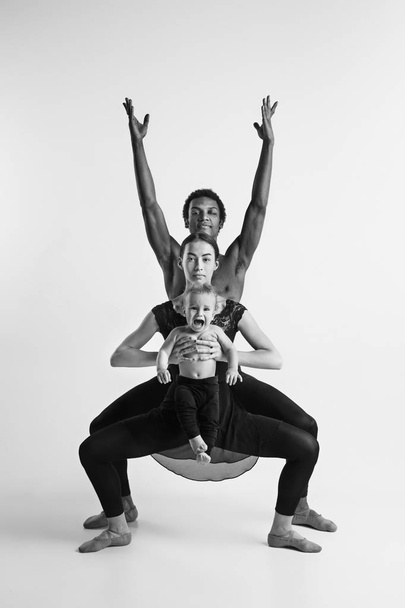 A happy family of ballet dancers on white studio background - Zdjęcie, obraz