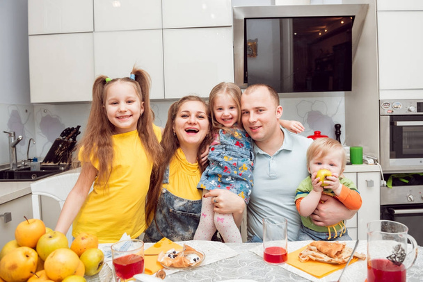 Cheerful young family having fun at home - Foto, Bild
