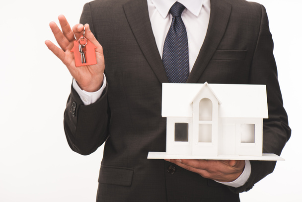 cropped image of man holding maquette of house with key isolated on white - Photo, Image