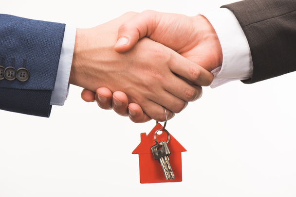 cropped image of shaking hands with key from house isolated on white - Photo, Image
