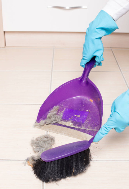 Barrer el suelo de baldosas con cepillo y recogedor
 - Foto, imagen