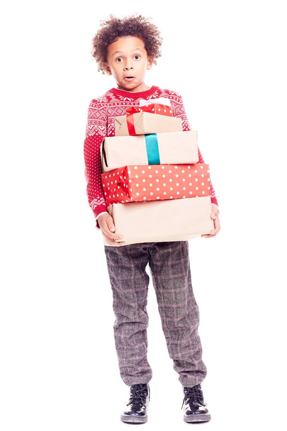 Boy with heap of Christmas gifts - 写真・画像