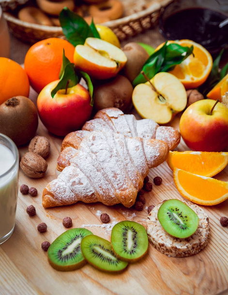 Healthy breakfast with milk, fruits and croissants - Fotó, kép