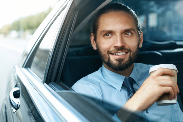 Man Drinking Coffee In Car Portrait - Foto, afbeelding