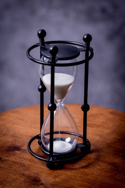 Hourglass on wooden table, selective focus - Photo, Image
