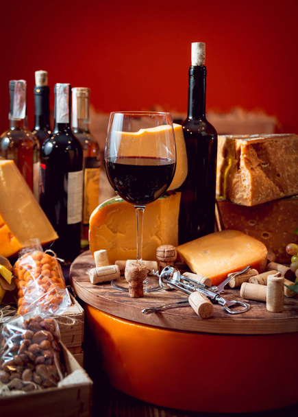 Cheese and wine on a wooden table - Valokuva, kuva