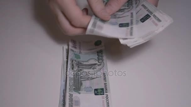The man counts money Russian ruble over white table slow motion hd footage - Imágenes, Vídeo