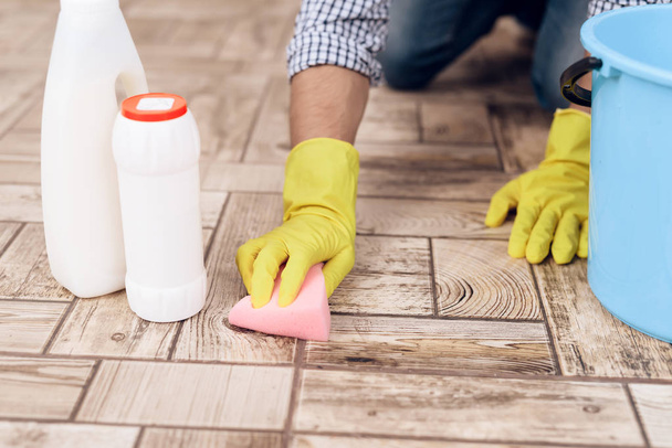 Ένας άνθρωπος που τον καθαρισμό του δαπέδου στο διαμέρισμα. Πολυτεχνίτης είναι ο καθαρισμός διαμερίσματος - Φωτογραφία, εικόνα