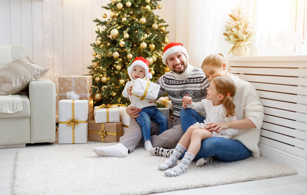 famiglia madre padre e figli a casa la mattina di Natale
 - Foto, immagini