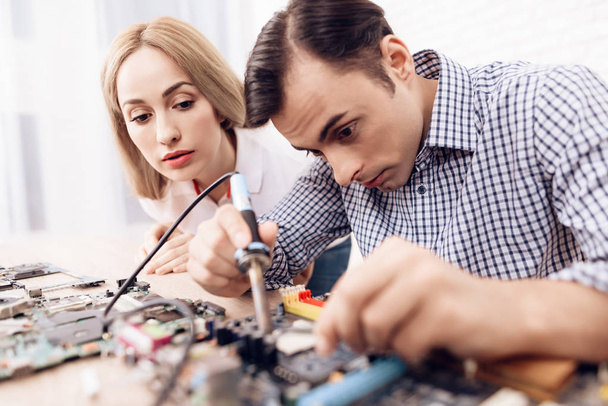 The man works as a radio technician. A man is repairing printed circuit board. - Φωτογραφία, εικόνα
