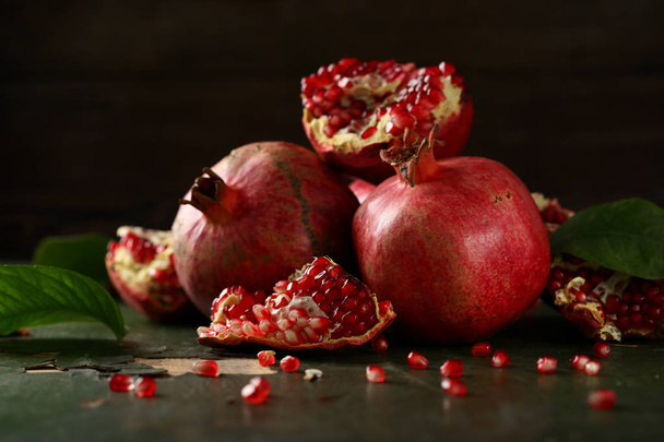 sweet pomegranates on dark wood - Фото, изображение