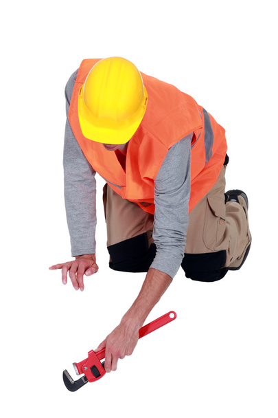 Tradesperson using a pipe wrench - Photo, image
