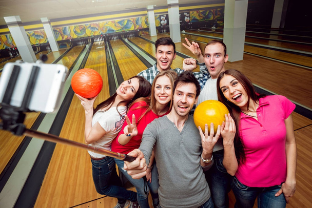 Cheerful friends at the bowling alley doing selfie - Photo, Image