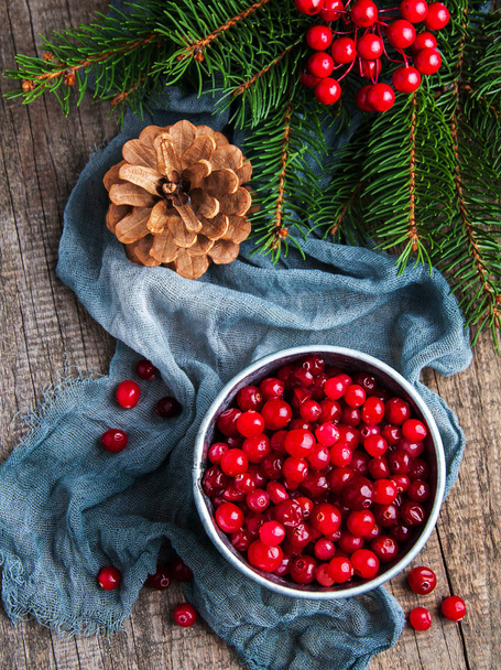 Red cranberries on a old wooden table - Photo, image