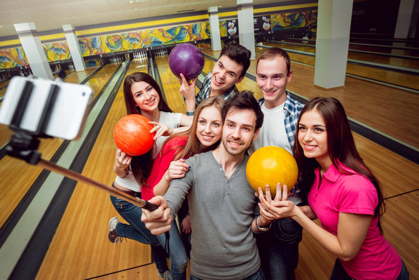 Cheerful friends at the bowling alley doing selfie - Photo, Image