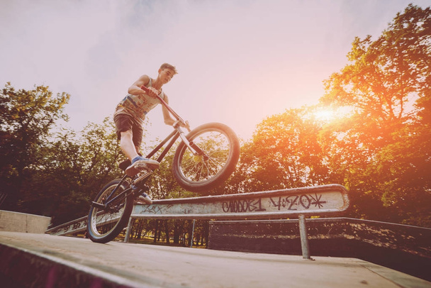 Teenager riding a BMX in skate park. - Photo, Image