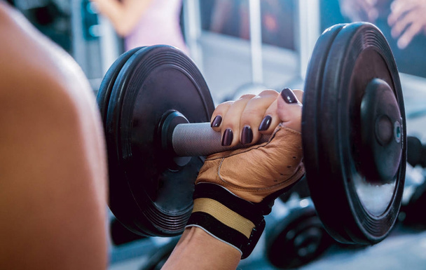 Dumbbell in womans hand, closeup - Photo, image