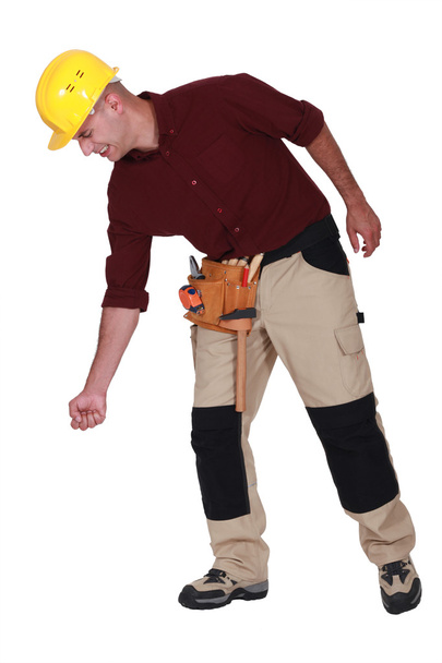 Builder struggling to lift - 写真・画像