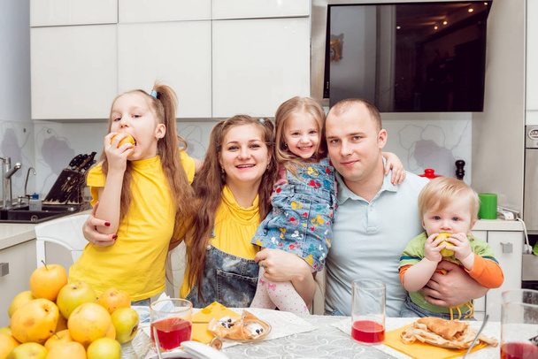 Cheerful young family having fun at home - Фото, изображение