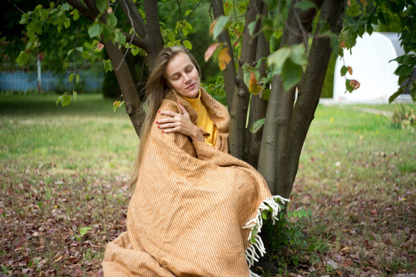girl is wrapped in a blanket - Фото, изображение