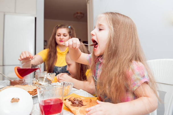 Cheerful family having good time during lunch in kitchen - Fotoğraf, Görsel
