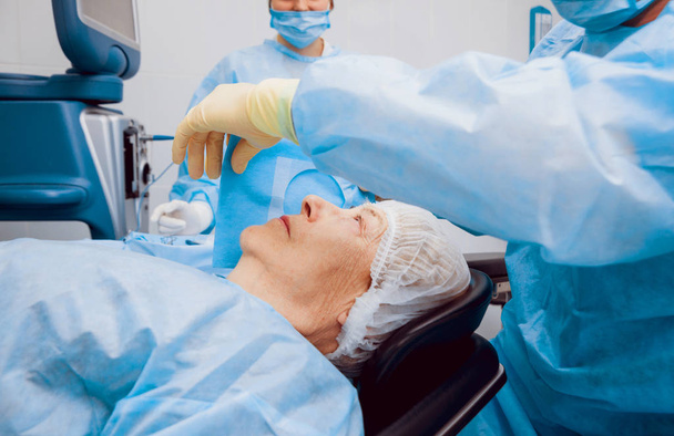 Operation on the eye of senior woman. Cataract surgery. Medical equipment.  - Valokuva, kuva