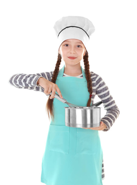 Cute girl in apron with whisk and saucepan on white background - Photo, image