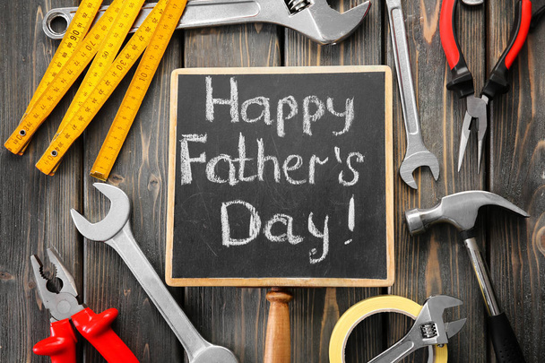 Set of tools with chalkboard on wooden background. Father's Day concept - Foto, Bild