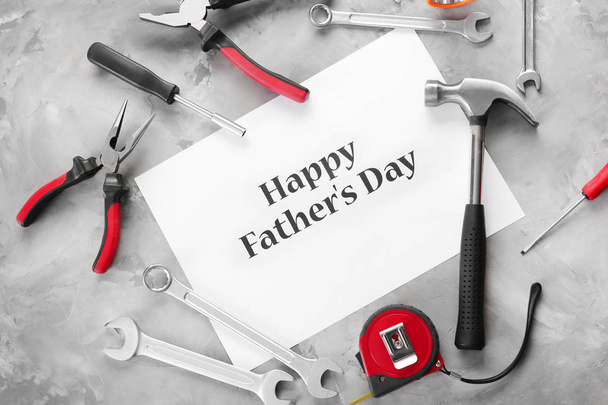 Set of tools with greeting card on grunge background. Father's Day concept - Φωτογραφία, εικόνα