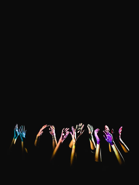 banner κοινωνική αντίληψη. τα χέρια στο χρώμα που υψώνεται πάνω σε μαύρο φόντο, που συμβολίζει το φόβο, ελπίδα, αγώνα και ένα αίτημα για βοήθεια. Θέση για κείμενο, πνευματικά δικαιώματα - Φωτογραφία, εικόνα