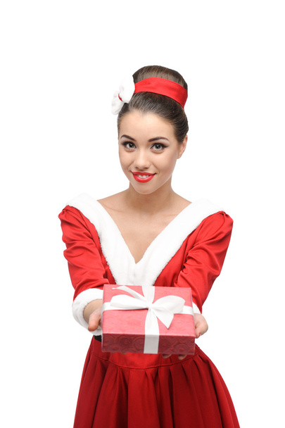 Cheerful retro girl holding red gift - Foto, afbeelding