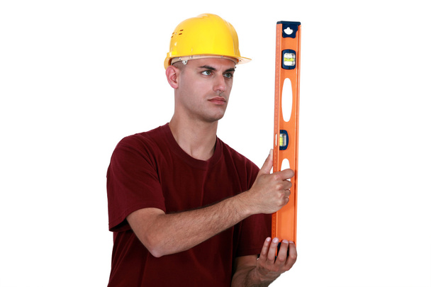 Craftsman holding a level - Foto, afbeelding